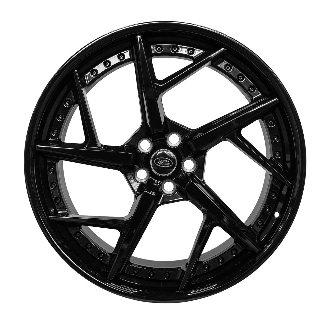 A glossy black Double-spoke alloy wheel rim with a five-spoke design and a central oval badge, shown against a plain white background.