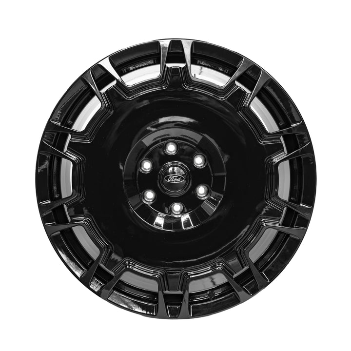 A glossy black multi-spoke aftermarket vehicle wheel rim with a Ford logo in the center, isolated on a white background.