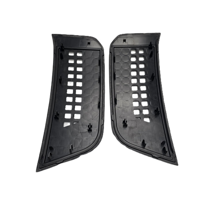 A pair of black plastic automotive side vent trim pieces with a honeycomb pattern and square cutouts, shown on a plain white background.

