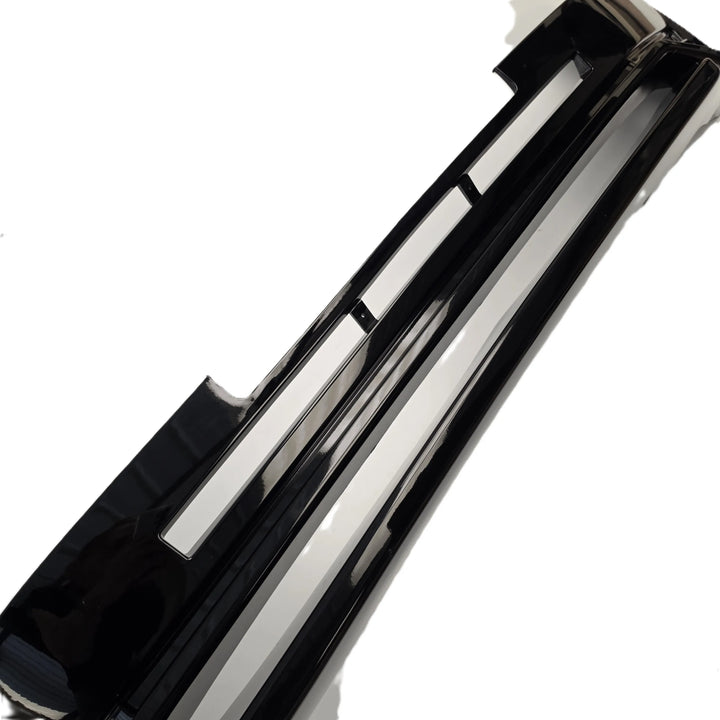A glossy black automotive bumper trim piece for a defender L663, shown on a plain white background.