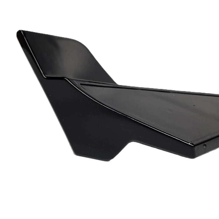 A close up shot of the reverse end of a rear bumper canard finished in a glossy black
