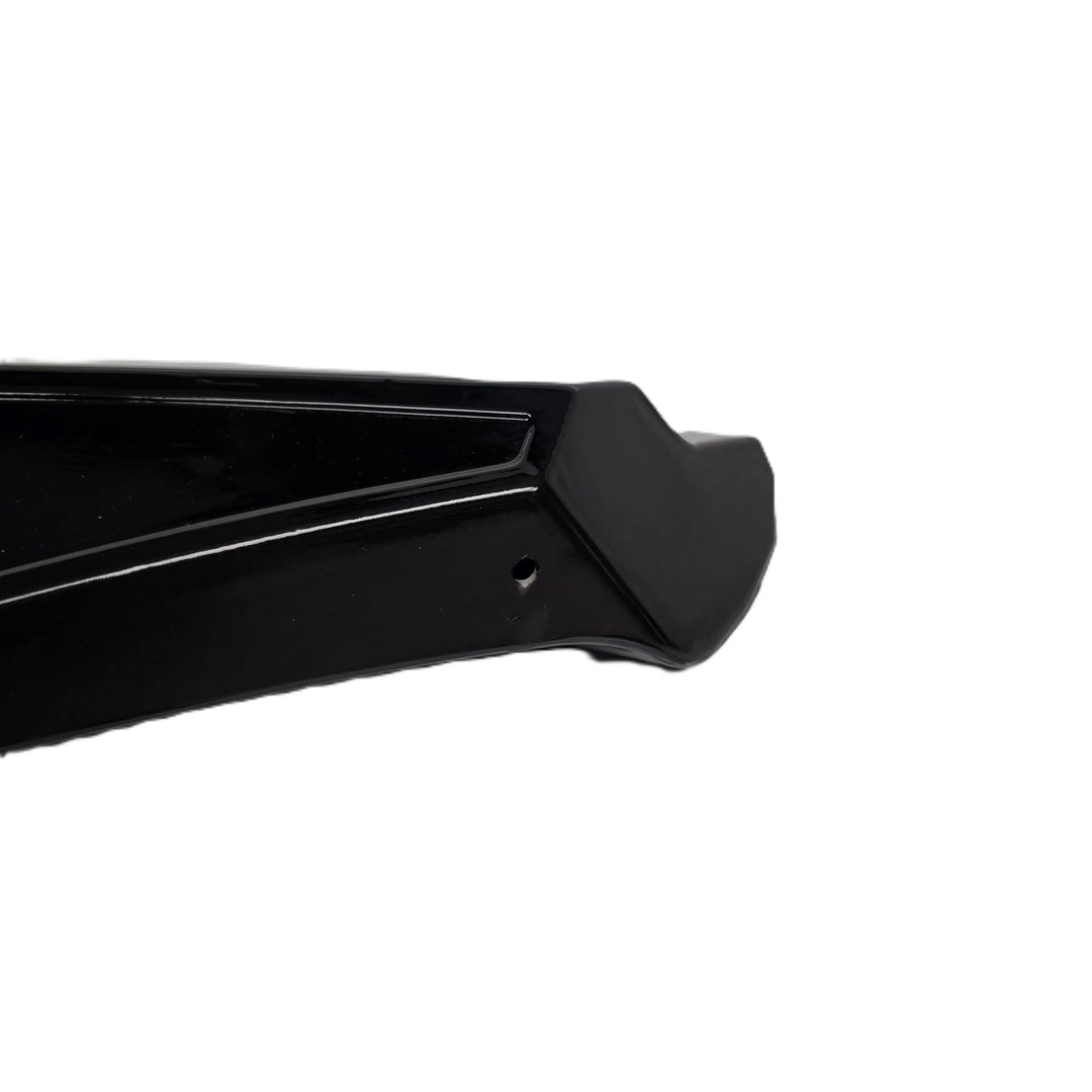 A close up shot of the reverse end of a rear bumper canard finished in a glossy black