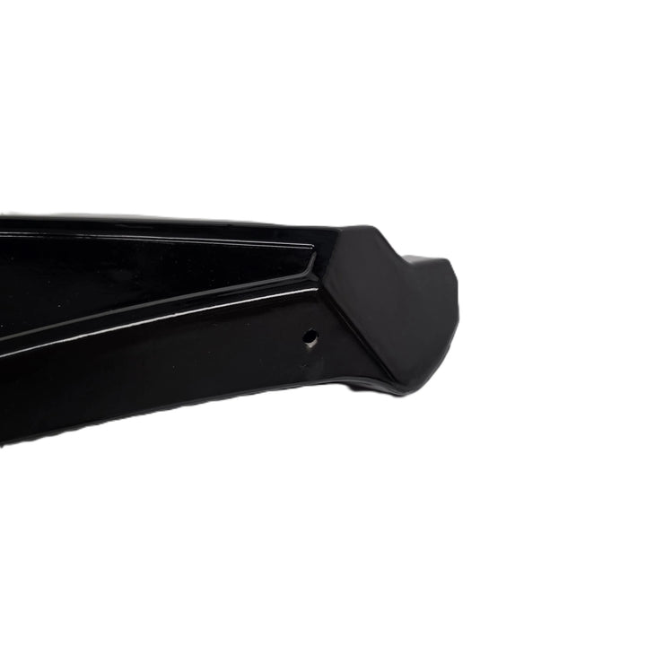 A close up shot of the reverse end of a rear bumper canard finished in a glossy black