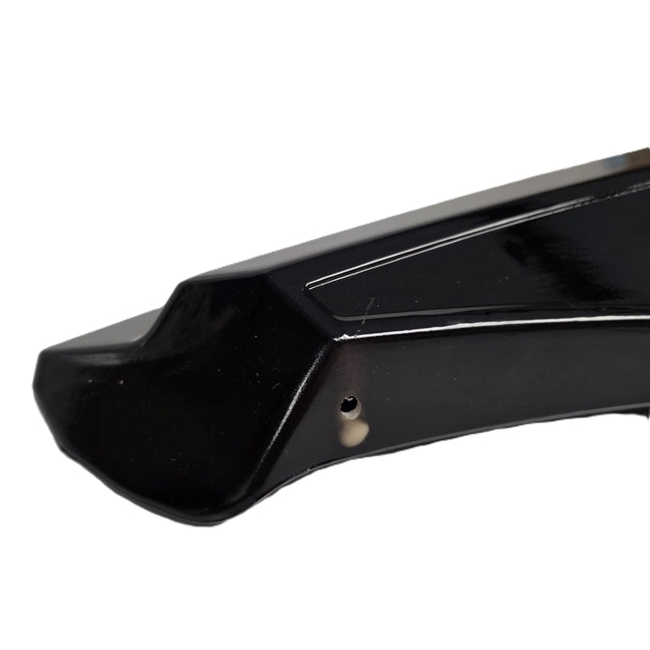A close up shot of the reverse end of a rear bumper canard finished in a glossy black