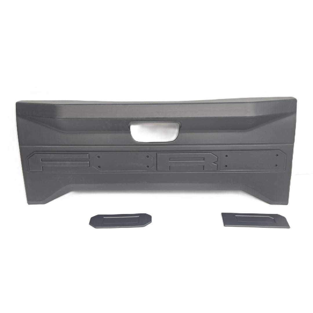 A Black tailgate moulded plastic cover by sterling automotive, shown on a white background with two Ford Partly shown with the O & D lettering separate to the tailgate cover