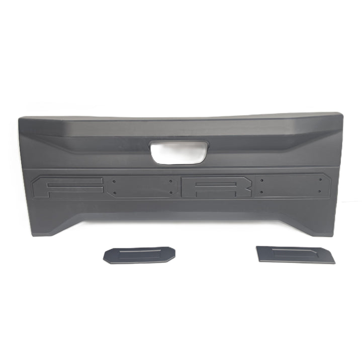 A Black tailgate moulded plastic cover by sterling automotive, shown on a white background with two Ford Partly shown with the O & D lettering separate to the tailgate cover