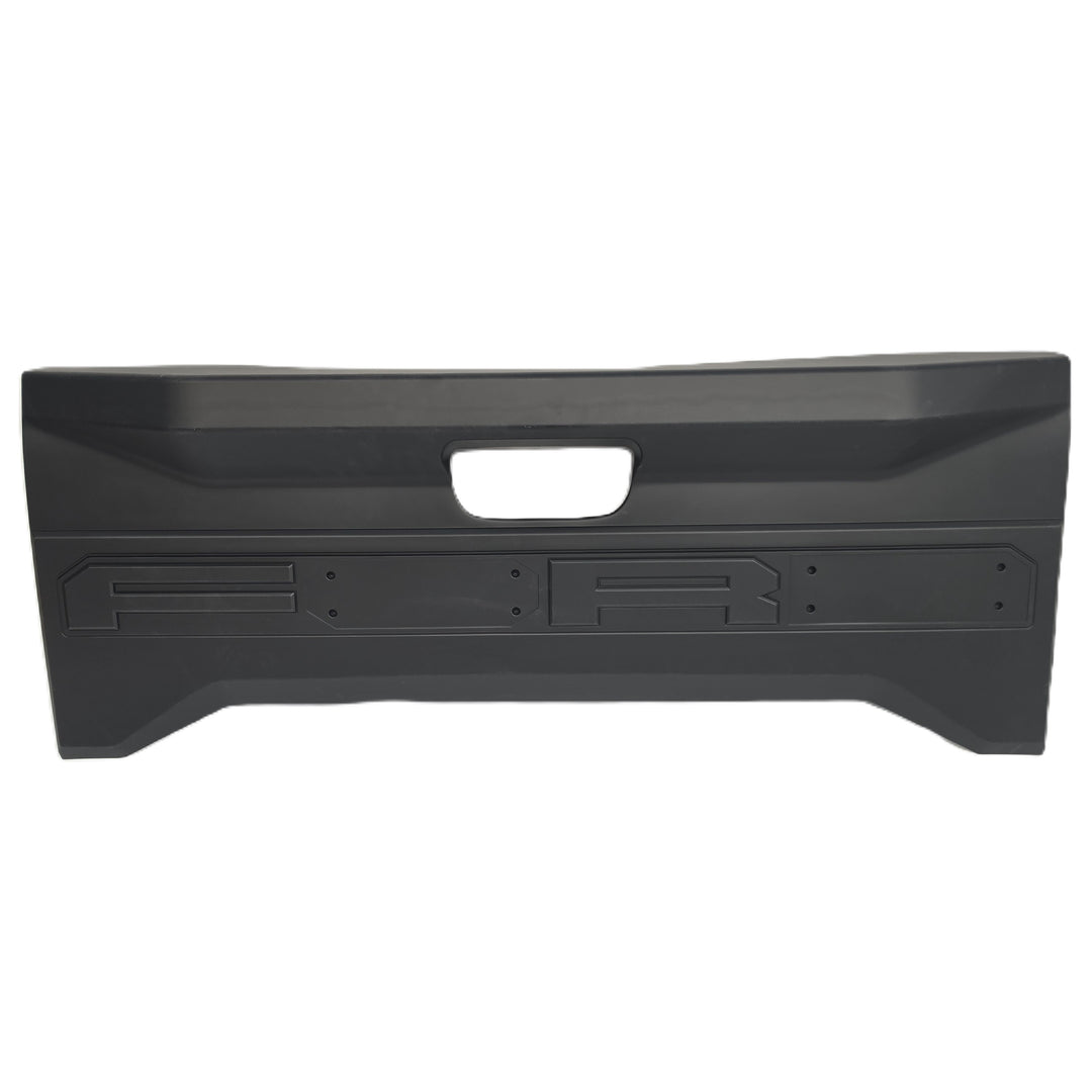 A black plastic rear tailgate cover by sterling automotive with a central cutout for the handle and moulded mounting slots for missing letters, lettering O & D missing from the tailgate cover shown against a plain white background.


