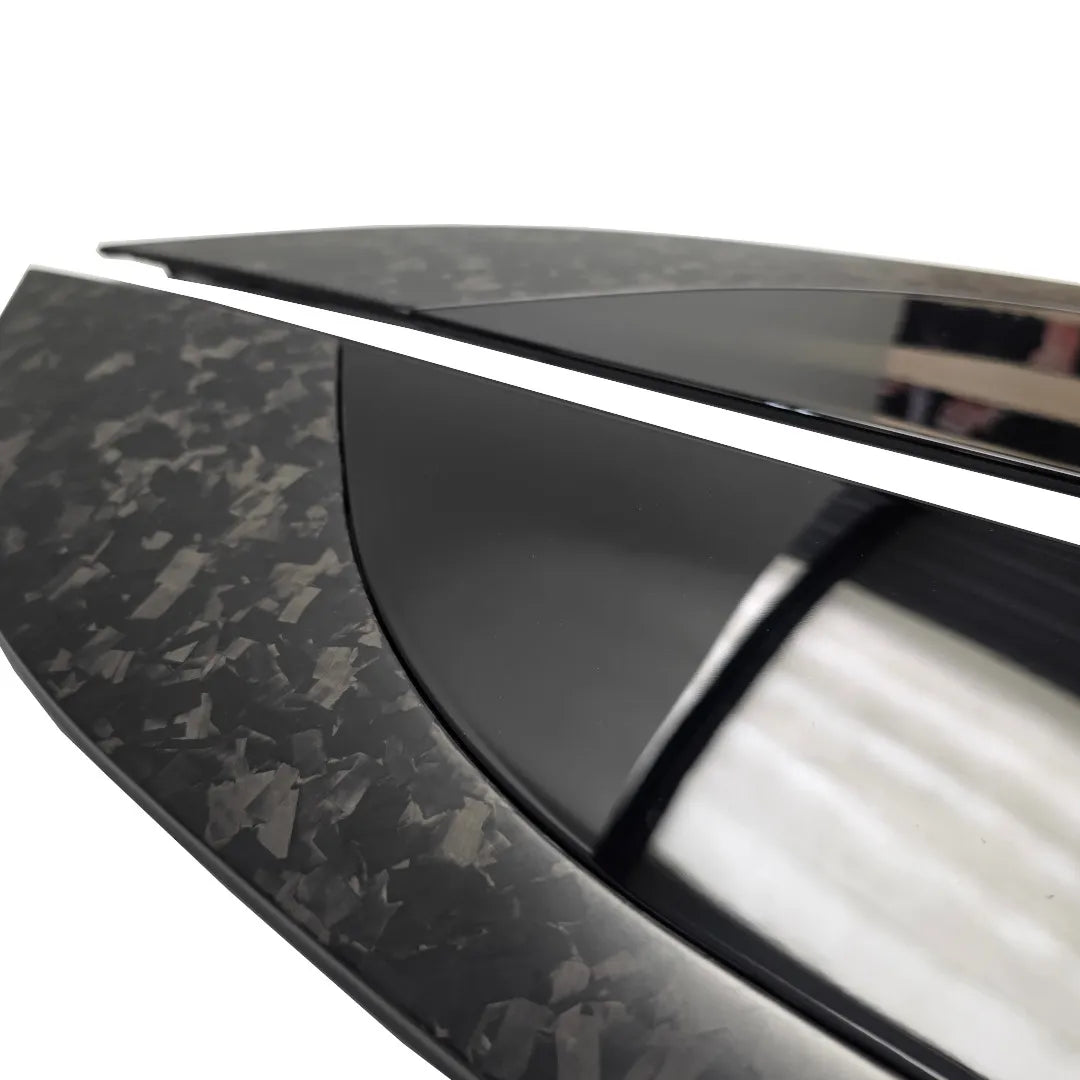Angles close up shor of a Pair of Forged Carbon Fibre and Gloss Black Bonnet vents Pair on a pure white background