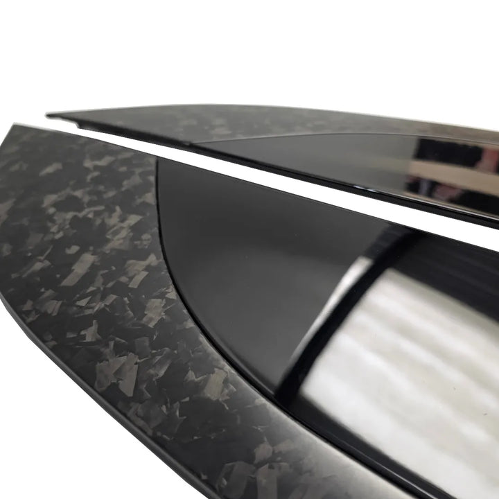 Angles close up shor of a Pair of Forged Carbon Fibre and Gloss Black Bonnet vents Pair on a pure white background