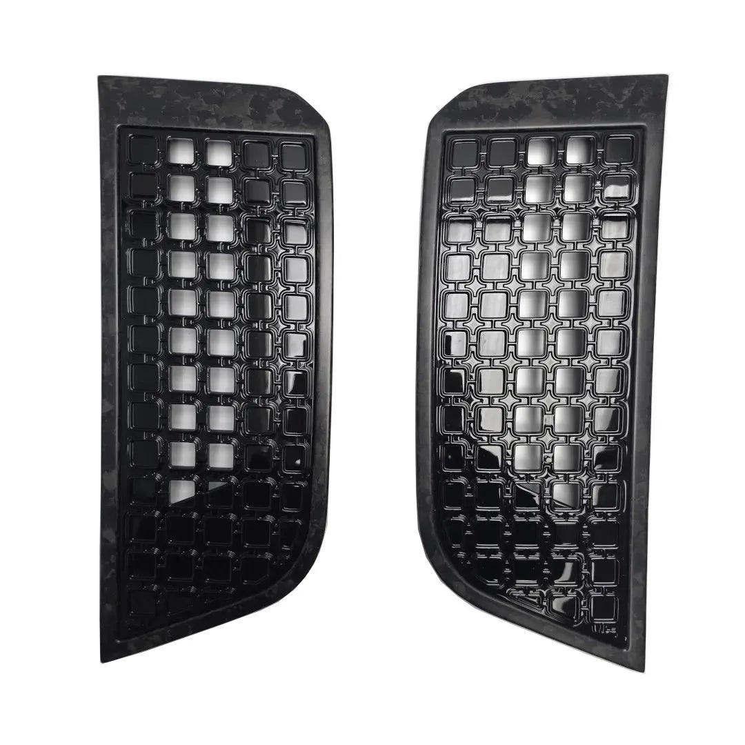 Two black car side vents with forged carbon surrounds with gloss black grid pattern on a white background