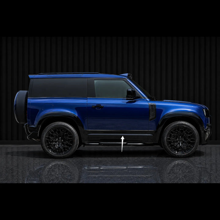 A blue SUV shown in side profile against a dark studio background with a reflective floor. A white arrow points to the side step/underbody trim area.