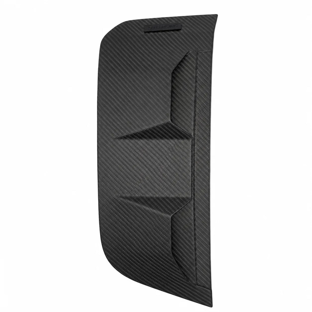 Close-up of a black carbon fiber textured product surface with a small embossed STERLING logo plaque, shown on a white background.