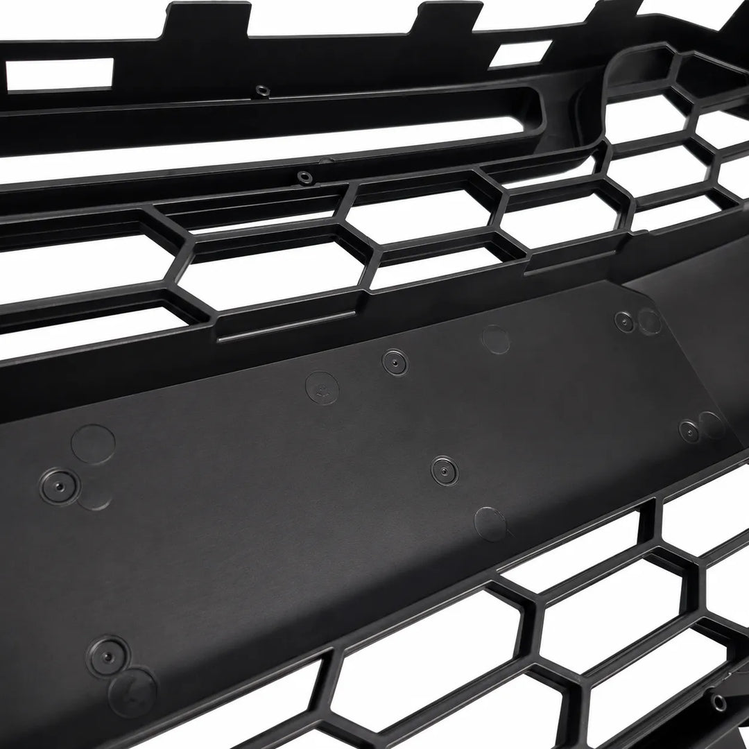 Close-up of a black honeycomb grille on a white background