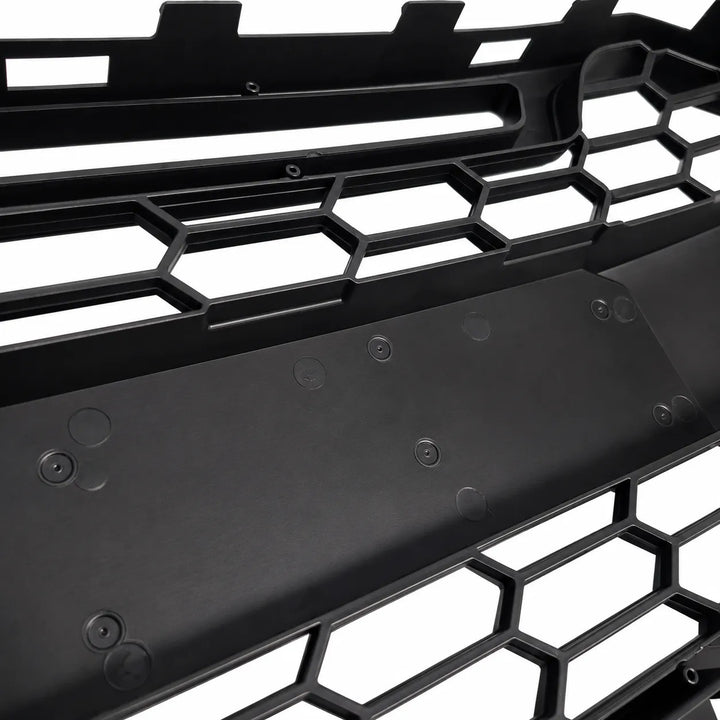Close-up of a black honeycomb grille on a white background