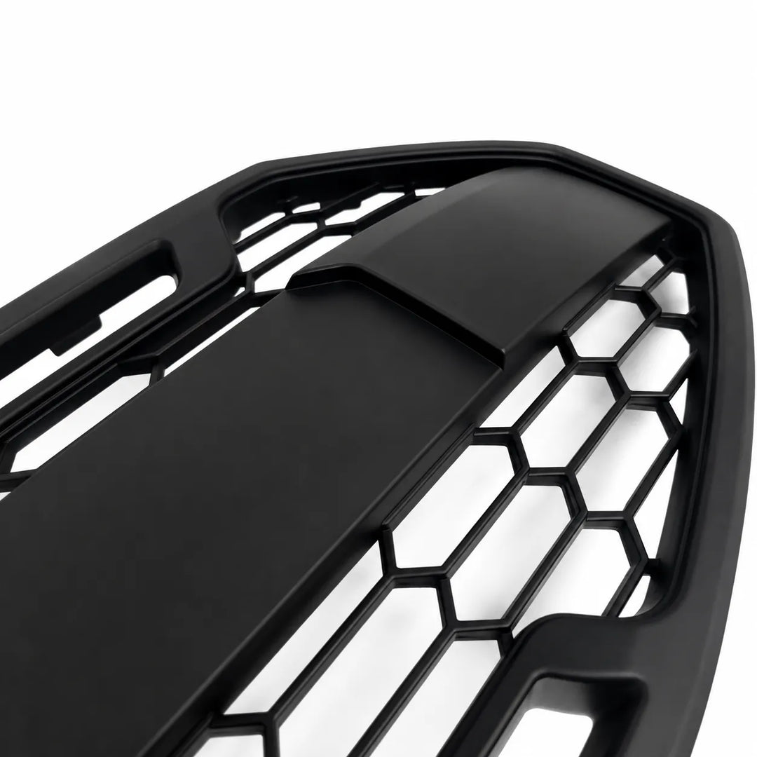 Close-up of a black honeycomb-patterned car grille on a white background