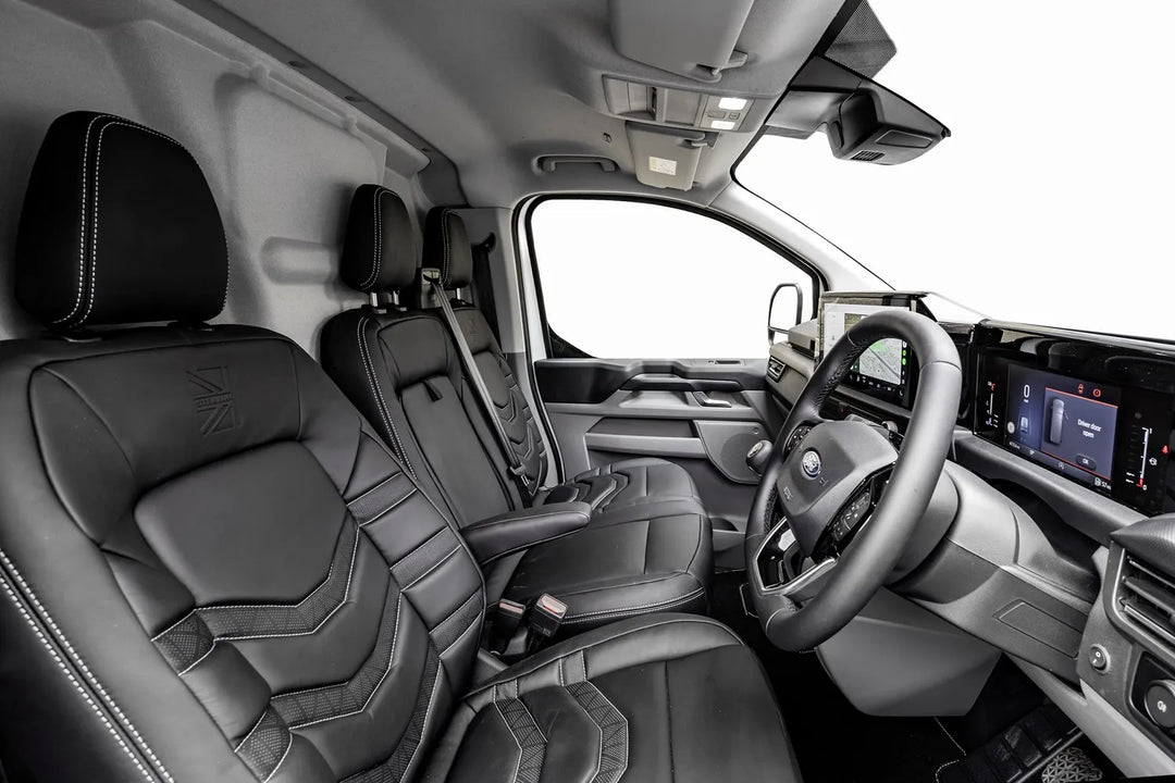 Interior of a vehicle with black leather seats and modern dashboard.