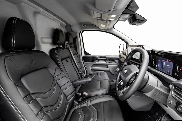 Interior of a vehicle with black leather seats and modern dashboard.