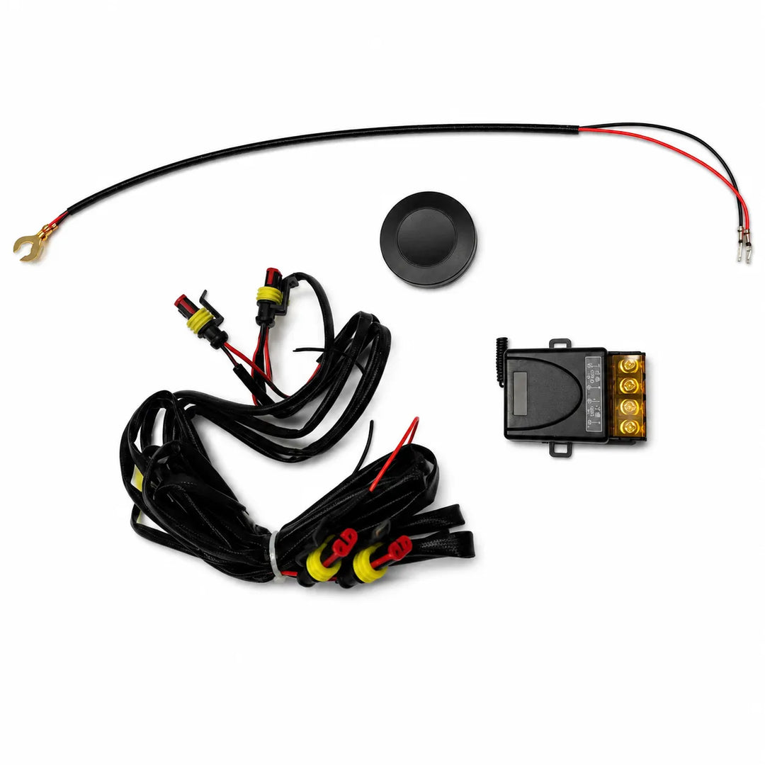 A wiring kit with a black wire harness, a black round component, a small black electronic module, and red/black terminal connectors on a white background.