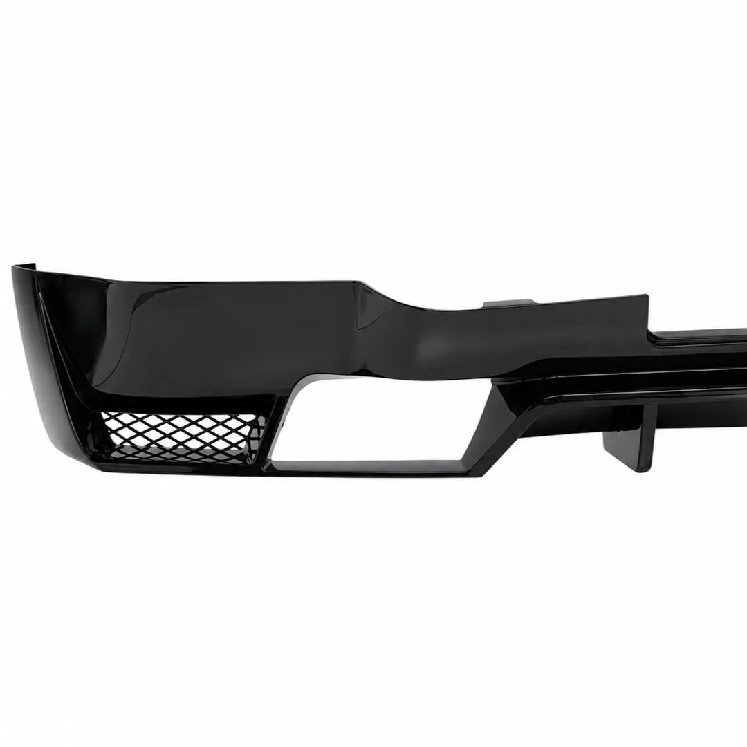 A glossy black automotive rear bumper lip or lower bumper trim Valance Diffuser piece with a mesh grille cutout, shown against a plain white background.