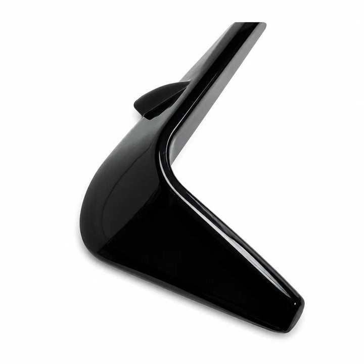 A close-up of a glossy black angular two notch front light fog surrounds winglets above on a white background., shown against a plain white background.