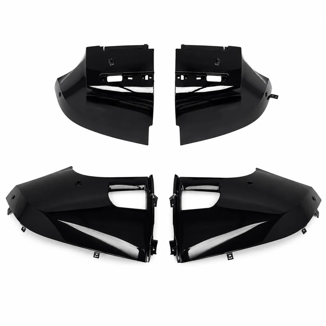 Four glossy black Defender Bumper Trim corner panels arranged in two pairs on a plain white background.