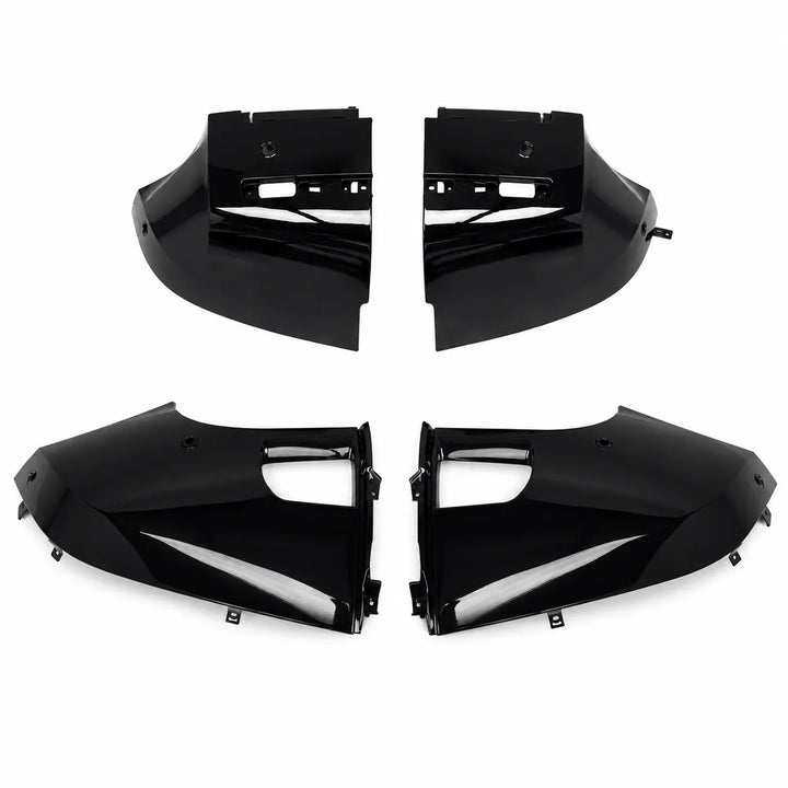 Four glossy black Defender Bumper Trim corner panels arranged in two pairs on a plain white background.