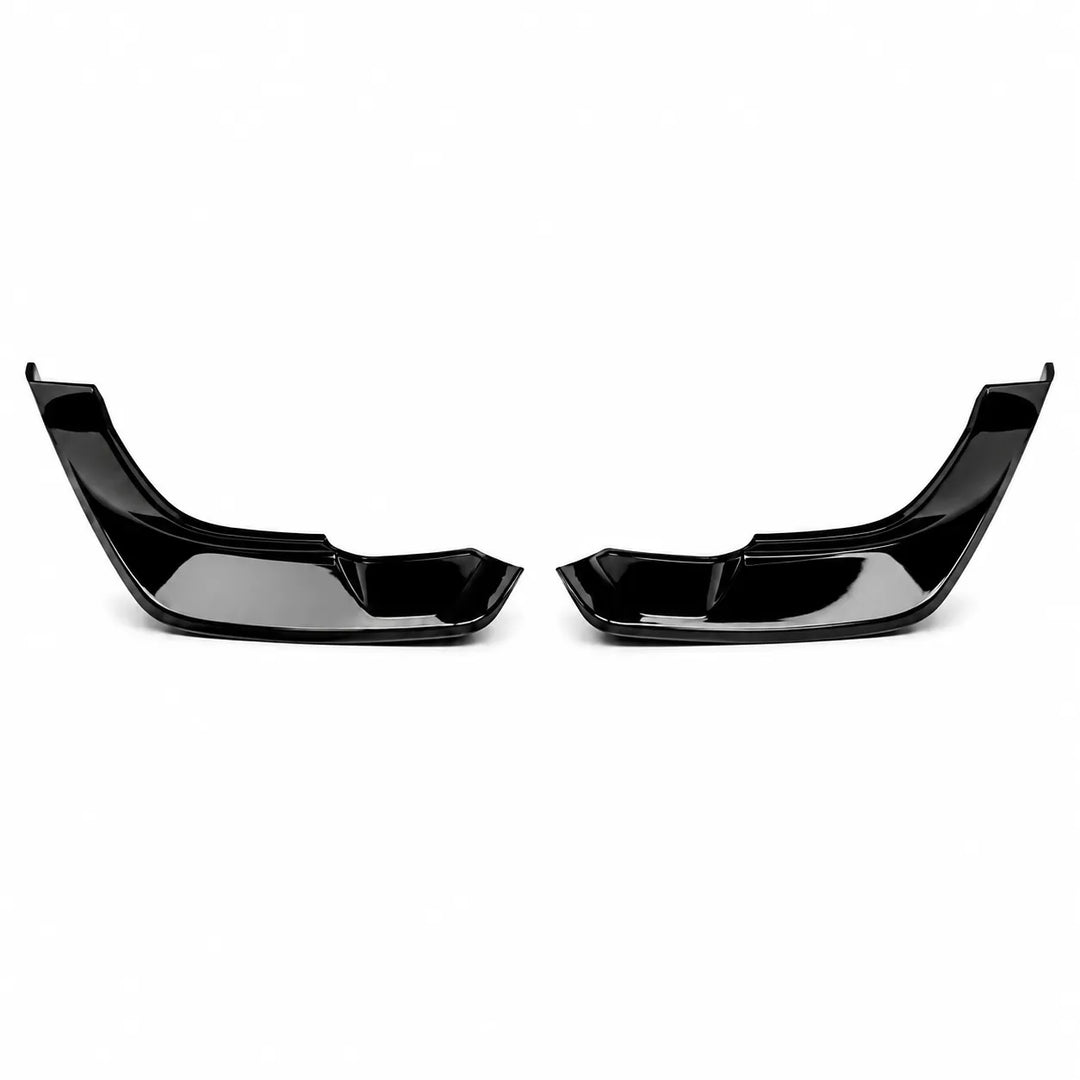 A pair of glossy black plastic automotive bumper canard trim pieces, bumper lip spoilers or front splitter inserts, displayed side-by-side on a clean white background.