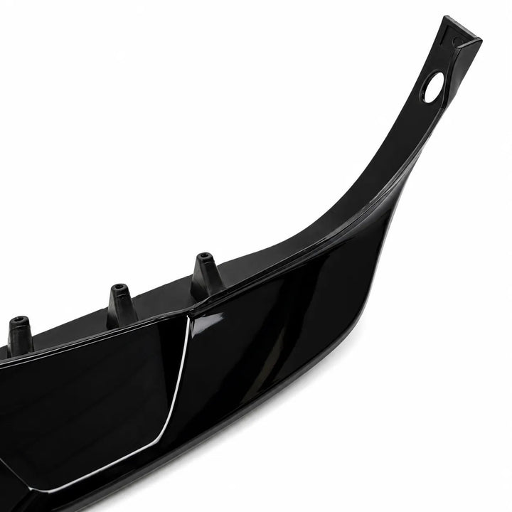 A glossy black plastic automotive bumper lip or front fascia bumper trim piece, with parking sensor hole, shown at an angle on a clean white background.