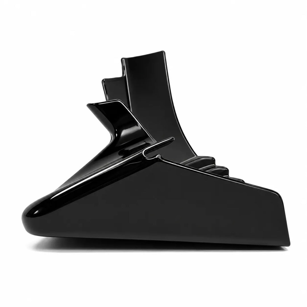 A single, side shot of a glossy black plastic lower bumper trim piece, low lip fender extension, no parking sensors shown against a plain white background.