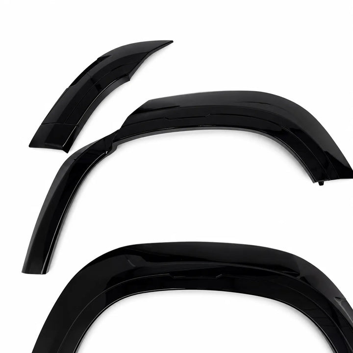 Three glossy black defender L663 Land Rover automotive Wide wheel Arch shown on a plain white background.