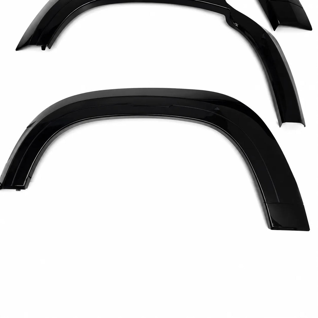 Three glossy black car wheel arches or fender extensions arranged on a plain white background.