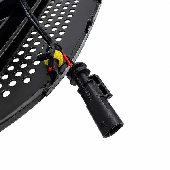 Close-up of a black electrical connector with wires on a white background