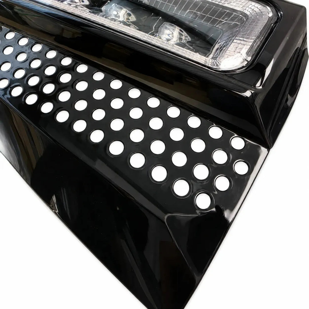 Close-up corner shot of a black LED light fog lamp with clear lens 4 LED lower fog lamp on a white background