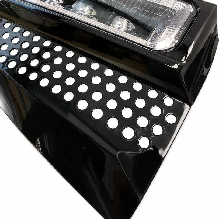 Close-up corner shot of a black LED light fog lamp with clear lens 4 LED lower fog lamp on a white background
