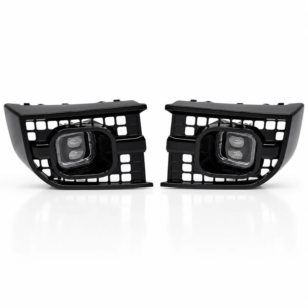 A pair of black automotive front fog lights with integrated grille grates and dual LED light elements, shown on a clean white background.