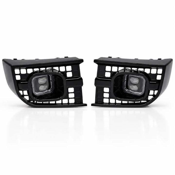 A pair of black automotive front fog lights with integrated grille grates and dual LED light elements, shown on a clean white background.