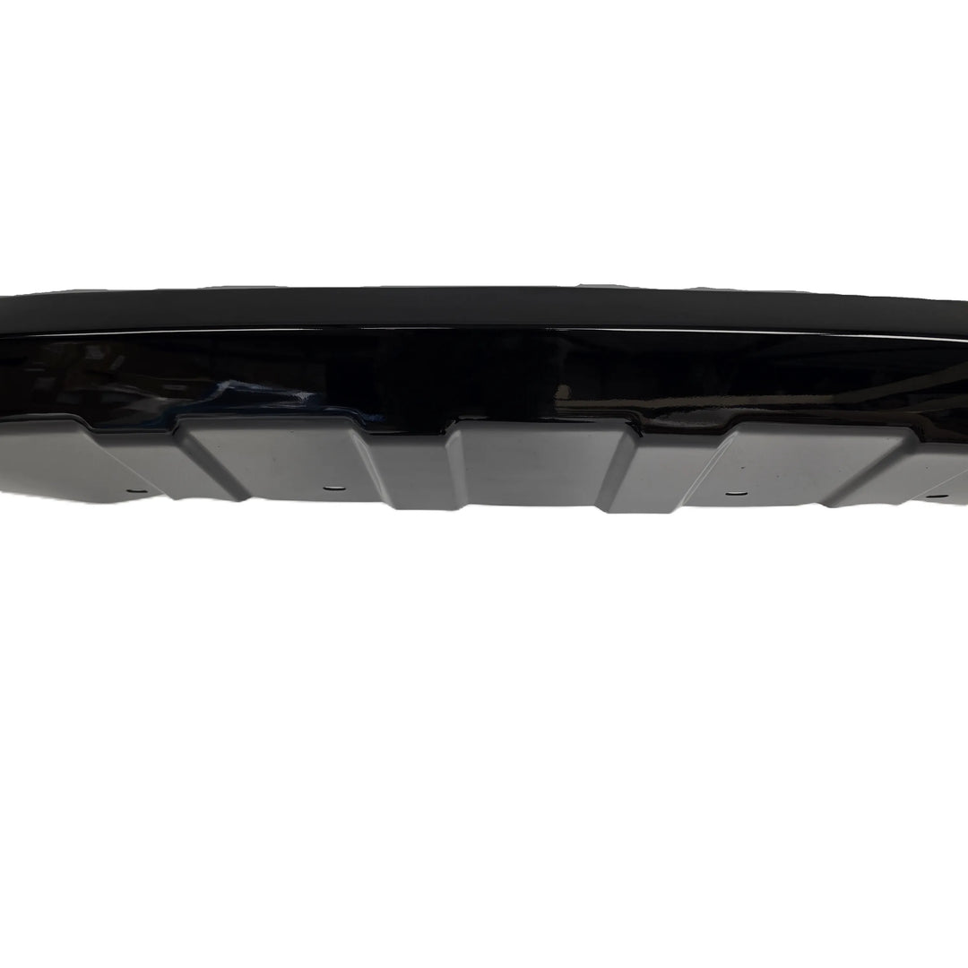 A close up shot of the middle of a glossy black plastic automotive bumper Khan style Look lip kit, displayed on a clean white background.