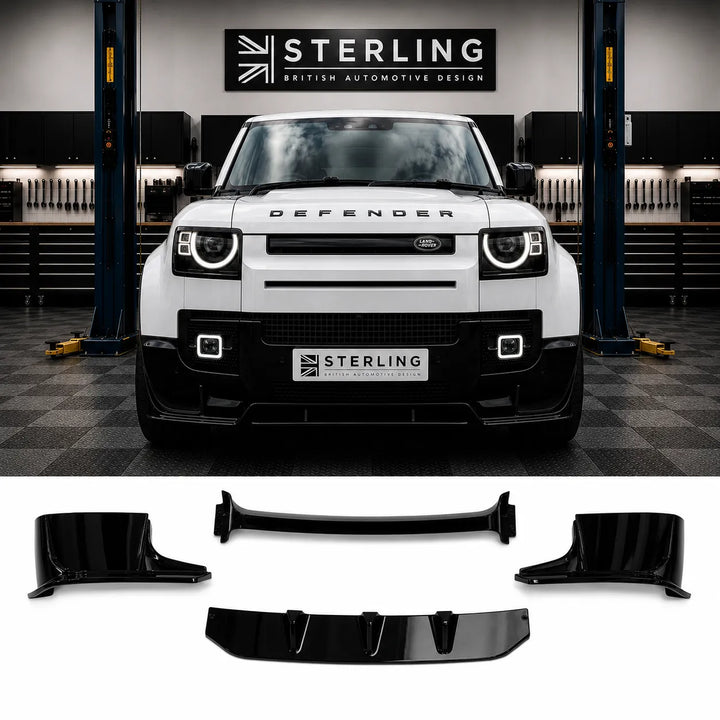 A white Defender SUV is shown in a garage setting with a black front lip spoiler kit displayed below on a white background. The kit is for a complete front bumper splitter