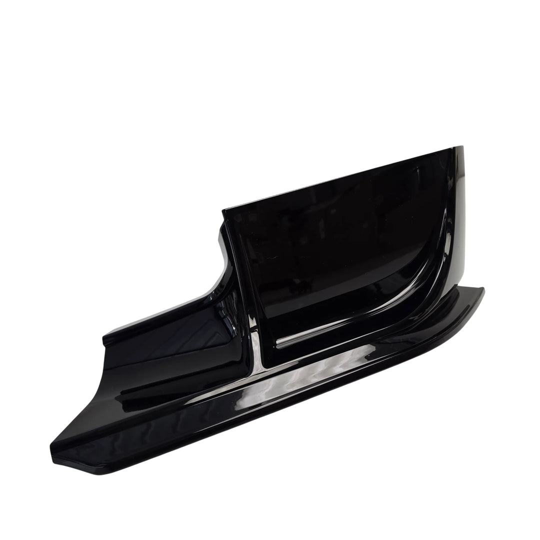 A glossy black lower automotive body fender trim piece, part of a front bumper splitter extension shown at an angle on a plain white background.