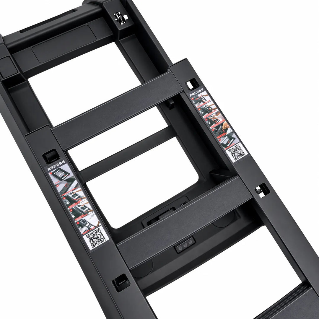 Close-up of a black metal ladder frame or step structure on a white background, showing the side ladder rails deployed in the second position and printed safety/instruction labels.