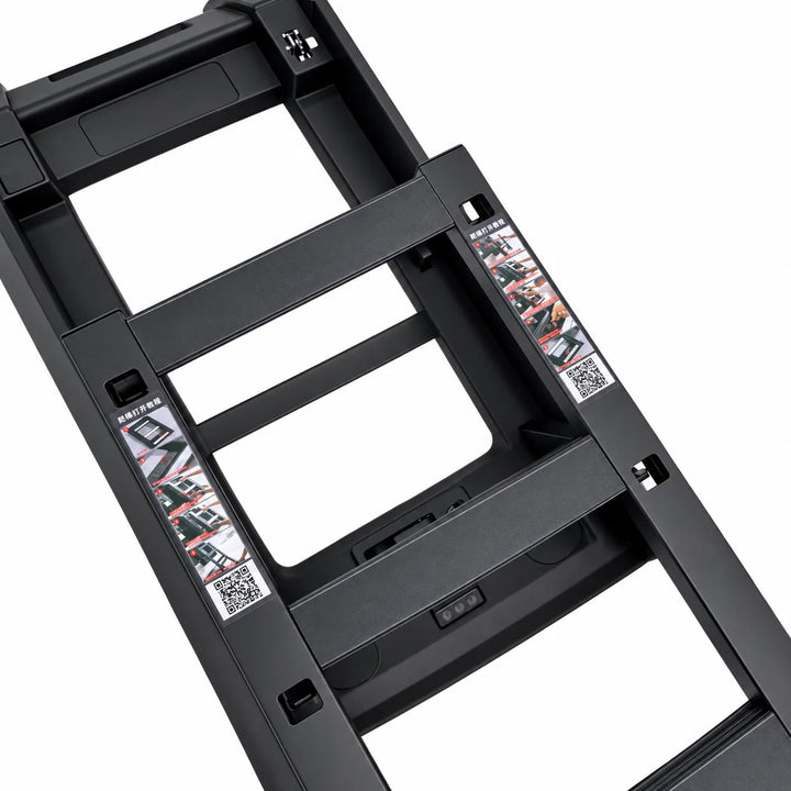 Close-up of a black metal ladder frame or step structure on a white background, showing the side ladder rails deployed in the second position and printed safety/instruction labels.