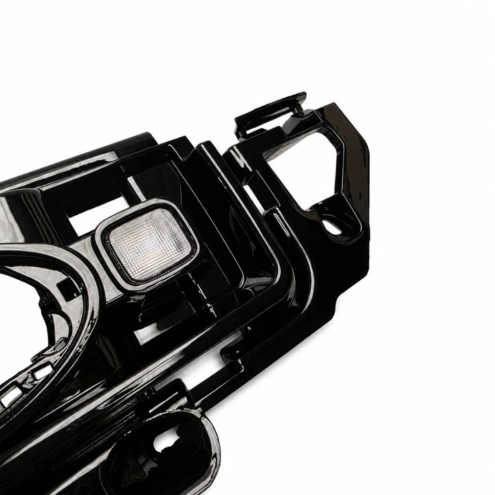 A glossy black plastic front Grille led light automotive grill assembly replacement upgrade trim piece with a small integrated light, shown on a plain white background.

