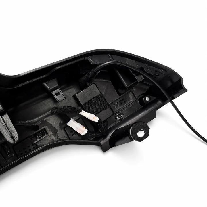 A close-up of a black plastic automotive led spoiler housing showing internal wiring, connectors, and mounting points on a white background.