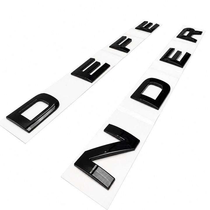 'Defender' bonnet lettering finished in black on a white background on an angle
