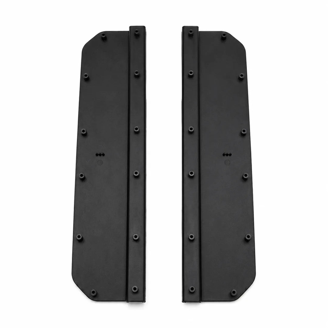 A pair of black Two protective side step foot panels with ribbed textures, shown on a plain white background. Compatible with L663 Defenderplates with pre-drilled screw holes, shown on a plain white background.