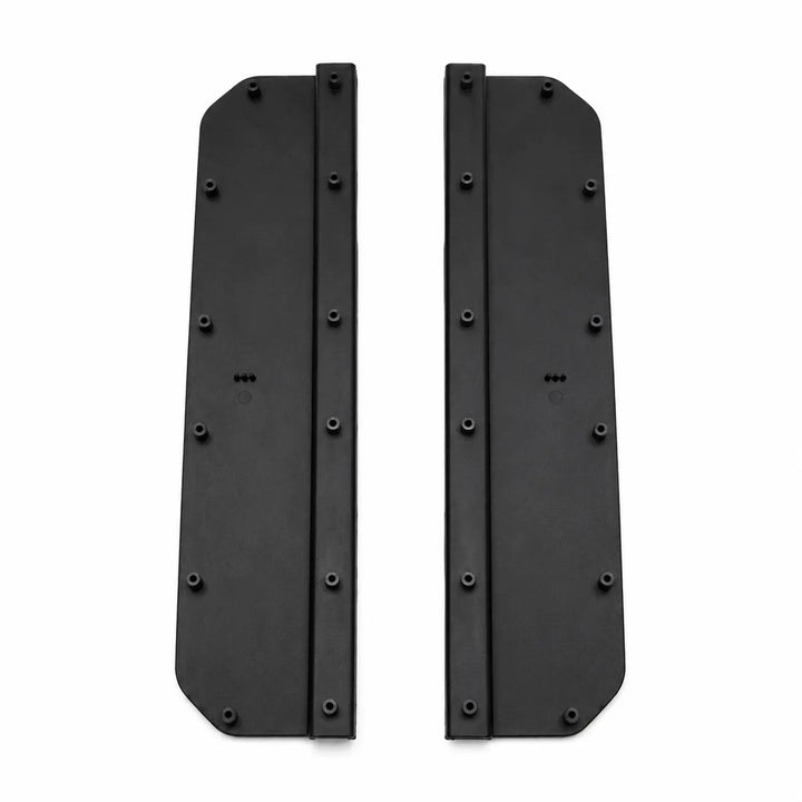 A pair of black Two protective side step foot panels with ribbed textures, shown on a plain white background. Compatible with L663 Defenderplates with pre-drilled screw holes, shown on a plain white background.