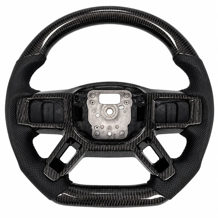 A carbon fiber steering wheel kit shown in one piece: a carbon top and bottom half of a steering wheel, and a matching inner center wheel trim piece below, on a solid white background.