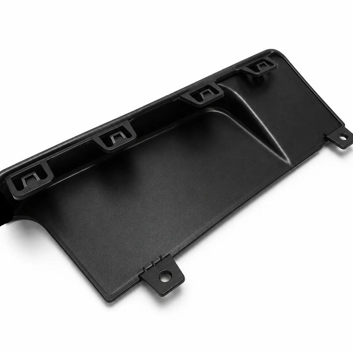 A black molded plastic automotive panel or trim piece with mounting tabs, shown on a clean white background.