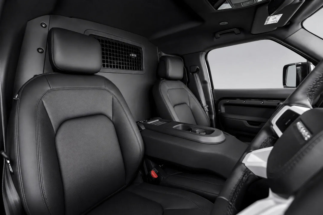 Black leather front cabin seats of a pickup L663 interior, including the driver's seat, passenger seat, center console, and steering wheel area.