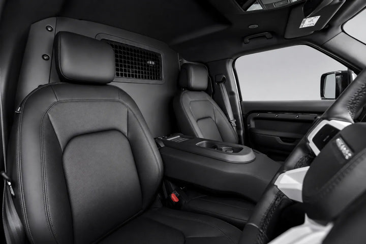 Black leather front cabin seats of a pickup L663 interior, including the driver's seat, passenger seat, center console, and steering wheel area.